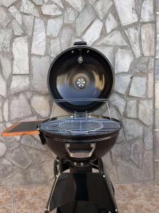 a grill with a pan on top of it at Trachos Traditional House in Sálakos