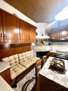 a kitchen with a couch and a table in it at Trachos Traditional House in Sálakos