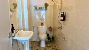 a small bathroom with a toilet and a sink at Baan YentaFo - Pink House 3rd floor in Chinatown