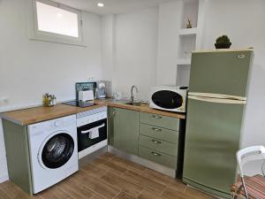 a kitchen with a washing machine and a washer and dryer at Julia's apartment in Marbella
