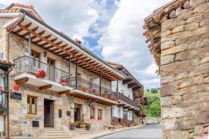 a street in a village with stone buildings at Quintanal de Villacarriedo in Villacarriedo