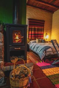 una camera da letto con camino con un letto e una stufa di Complejo Cabañas La Aguada a La Población Altre 54 foto
