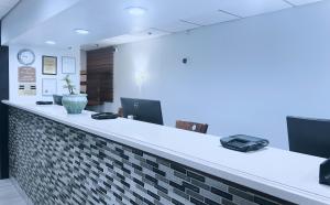 an office with a reception counter with a clock on the wall at Indy Hotel in Indianapolis +11 photos