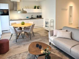 a living room with a couch and a table at Lichthuys 102 in Cadzand