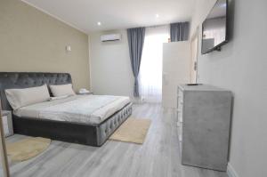 a bedroom with a bed and a television in it at Amy house Olbia in Olbia