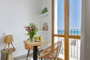 a room with a table and chairs and a view of the ocean at MIMAR ALTEA ROOMS - Tranquil in Altea