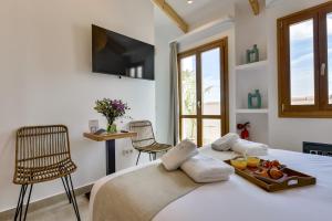a bedroom with a bed with a tray of food on it at MIMAR ALTEA ROOMS - Tranquil in Altea