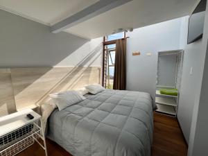 Postel nebo postele na pokoji v ubytování Yemanya Hostal