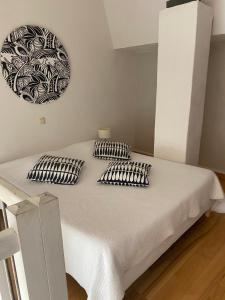 a bed with two pillows on it in a room at La Pastorale in La Bâtie-Neuve +59 photos