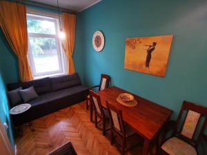 a living room with a couch and a table at Sombor 19 Central Apartment in Sombor