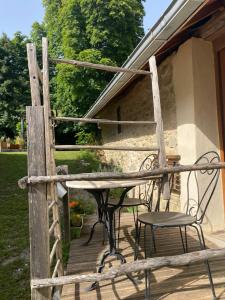 a table and chairs on a wooden deck at La Pastorale in La Bâtie-Neuve
