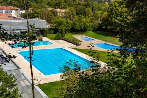 an overhead view of two swimming pools in a park at Black House- Sorprendente casa estilo industrial in Olot
