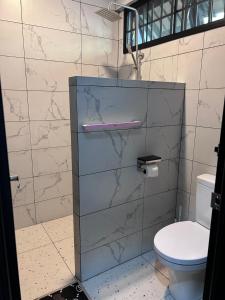 a bathroom with a toilet and a sink at Terap Homestay 500MB Wi-fi in Sibu +50 photos