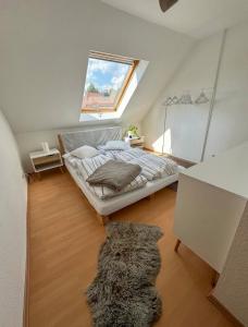 a attic bedroom with a bed and a window at Entspannungs Oase in Striegistal