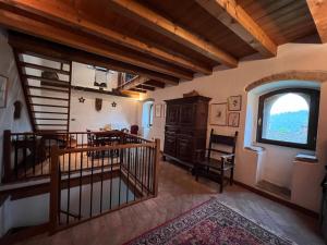 an attic room with a staircase and a window at Borgo Fontanini in Zocca