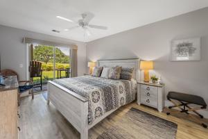 a bedroom with a bed and a ceiling fan at 55A 4th Hole Retreat at True Blue condo by Peace Vacations in Pawleys Island