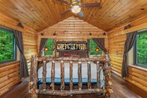 a bedroom with a bed in a log cabin at Smeagles Terrapin in Arbor Vitae WI in Boulder Junction