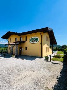 a building with a sign on the side of it at Agriturismo e Alloggi Luis Gianni in Cividale del Friuli
