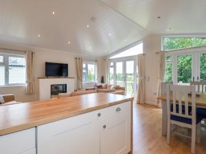 a kitchen and living room with a wooden counter top at 43 The Maples in St Austell