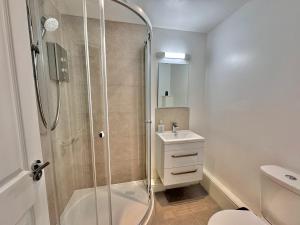 a bathroom with a shower and a toilet and a sink at One Moorgate View in York