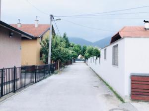 an empty street with houses and a fence at Villa Ilidza فيلا إليدزا in Ilidza