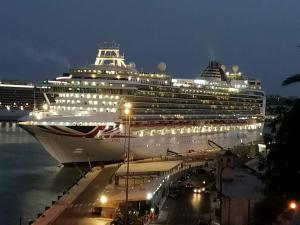a cruise ship docked in the water at night at Modern Elegance Valletta Apartment V1 in Valletta