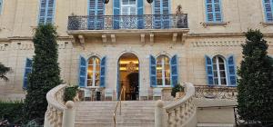 a building with a staircase in front of a building at Modern Elegance Valletta Apartment V1 in Valletta