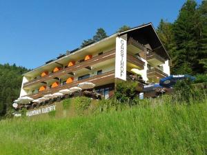 a hotel building with umbrellas on the side of it at Waldpension Rabeneck in Waischenfeld
