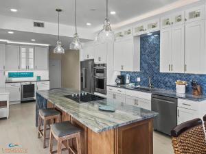 a large kitchen with white cabinets and a large island at ETW#6004-Penthouse Beachfront Condo–Amazing Views in Fort Walton Beach