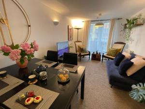 伦敦Lombok Apartment near Old Street,Islington,Angel的客厅里有一张桌子和一张蓝色沙发
