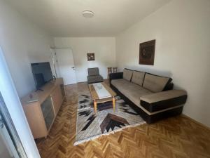 a living room with a couch and a tv at The Great Escape in Bitola