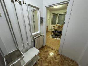 a hallway with a bench and a window and a table at The Great Escape in Bitola
