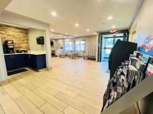 a lobby of a store with a cash register and a room at AmericInn by Wyndham Glendale Milwaukee in Glendale