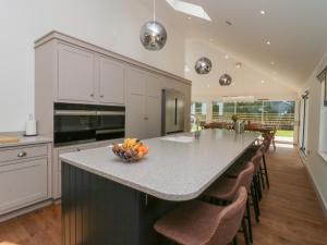 a kitchen with a island with a bowl of fruit on it at Heather's Cottage in Carlisle