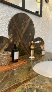 a bathroom counter with a sink and a mirror at Merian's House in Fethiye