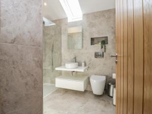 a bathroom with a toilet and a sink and a shower at Heather's Cottage in Carlisle +18 photos