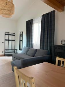 a living room with a couch and a table at EQUIFLY naturalhouse alloggio turistico in Manziana