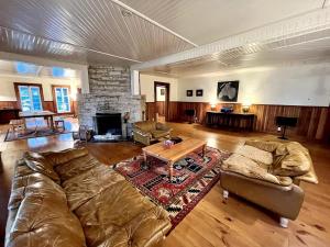 a large living room with a couch and a fireplace at Family Cottage Sheep Island in Delta