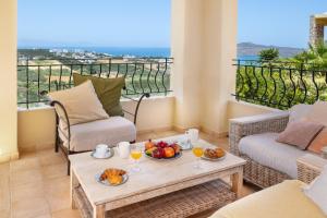 a living room with a table with food and drinks at Pasiphae villas 1 & 2 in Stalos