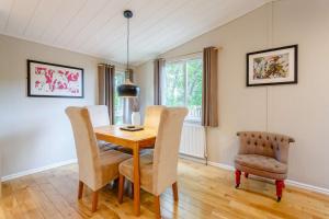 a dining room with a table and two chairs at Blenheim Lodge 21 in Kingham