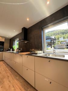 una cucina con un lavello e una grande finestra di Tromsø Arctic Villa with free parking a Tromsø