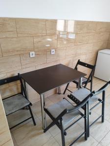 a black table and two chairs in a room at Apartament Luna in Jurilovca +2 photos