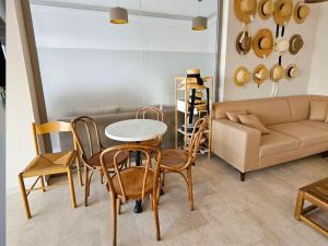 a living room with a table and chairs and a couch at Azure Bay in Karaoğlanoğlu