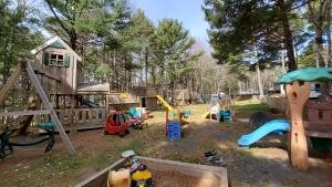 a playground with play equipment in a yard at Oakhill Pines Campground in Bridgewater