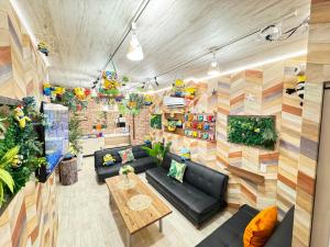 a living room with a couch and a table at New open Hotel Jungle fun fun J4 USJ 8minutes nishikujyo 3minutes in Osaka