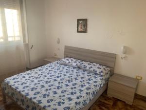 Una cama o camas en una habitación de Villa fronte spiaggia in salento torre mozza