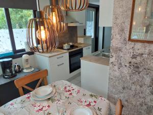 a kitchen with a table and a dining room at Opeteukske in Lanaken