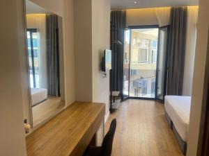 a hotel room with a bed and a large mirror at Dia Mare Deluxe in Vlorë