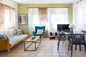 a living room with a couch and a table at Pasiphae villas 1 & 2 in Stalos