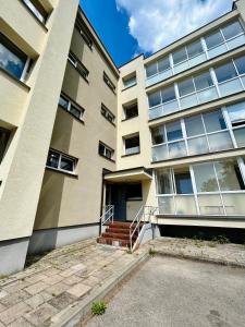 an apartment building with stairs in front of it at Vivist apartments in Druskininkai +11 photos